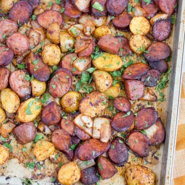 A sheet pan filled with with Potato and Sausage