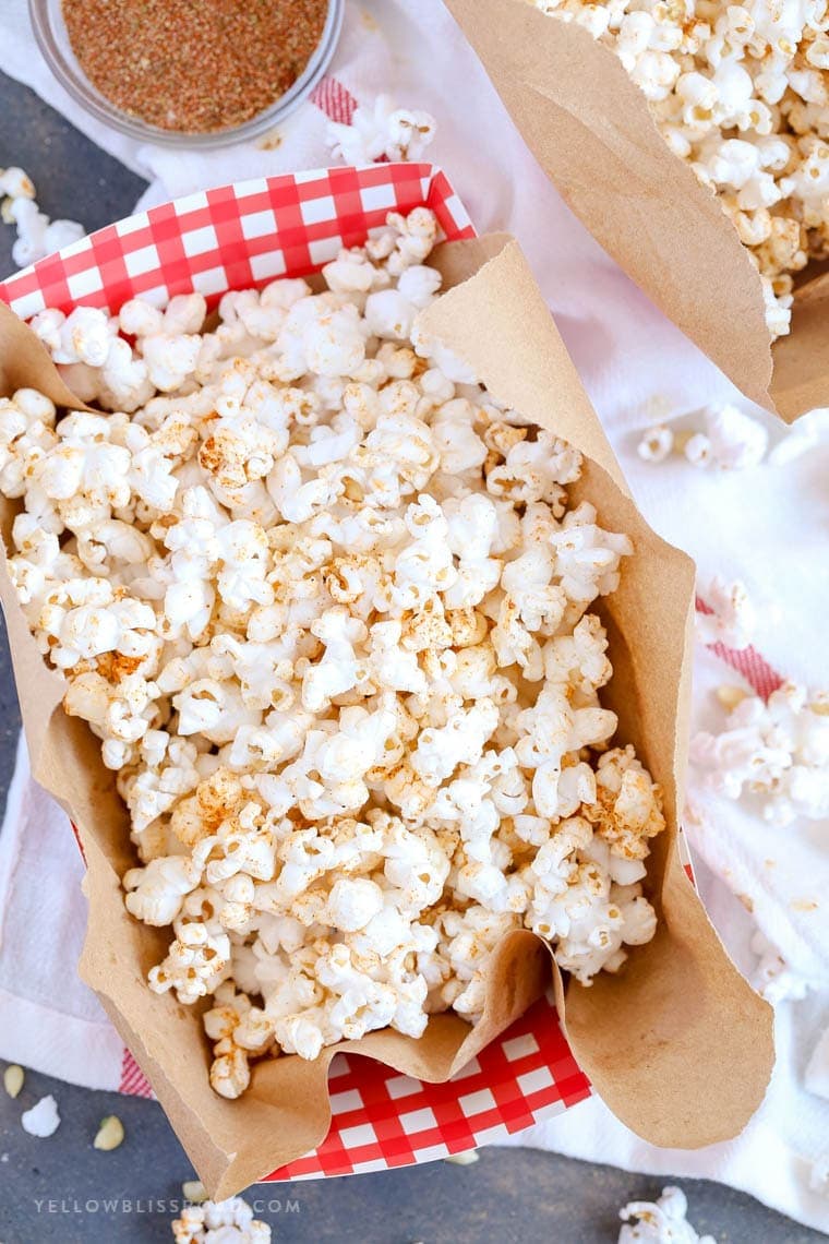 Hot Buttered Cajun Popcorn made with a Homemade Cajun Seasoning Blend in a red and white gingham bowl