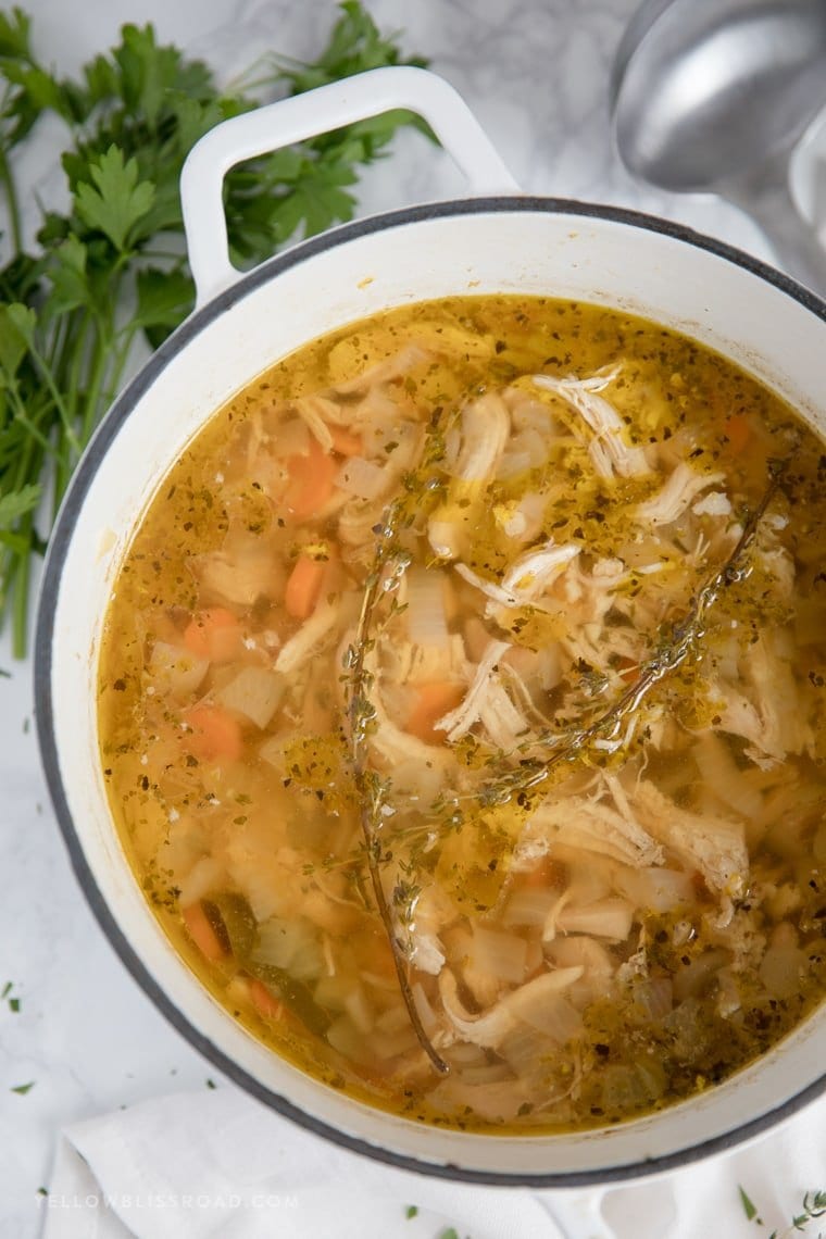 Chicken soup in a large white pot