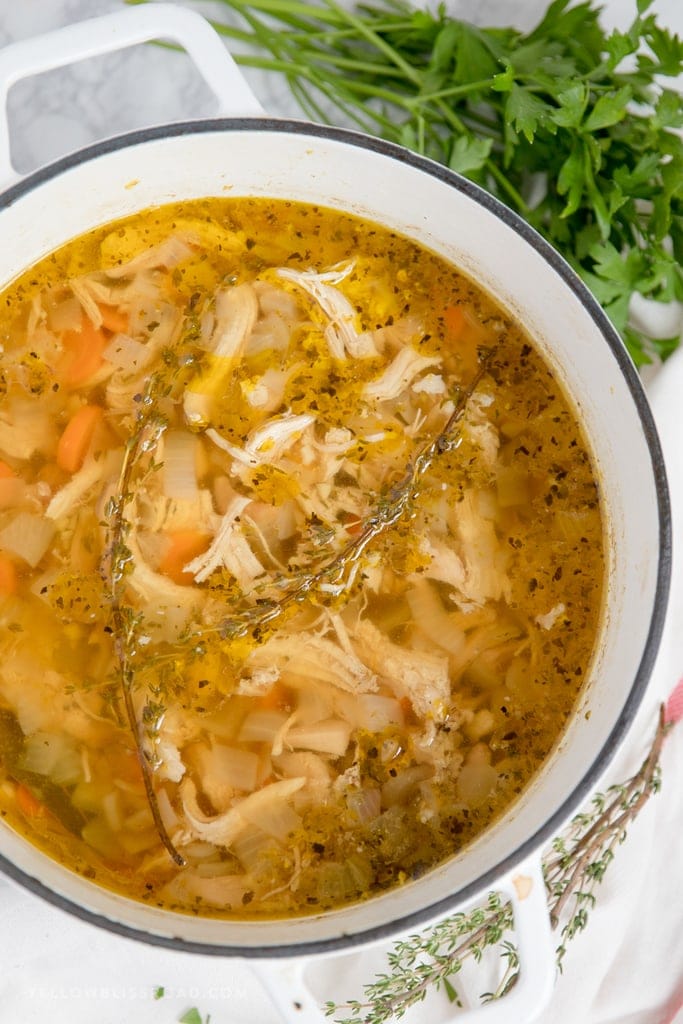 an overhead image of a large pot of chicken soup