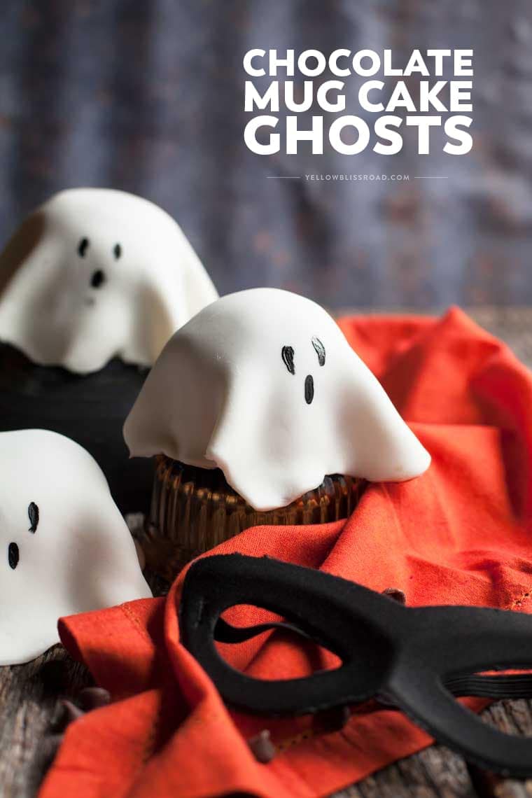 Such a fun Halloween Treat! Microwave Chocolate Mug Cakes topped with white fondant "ghosts."