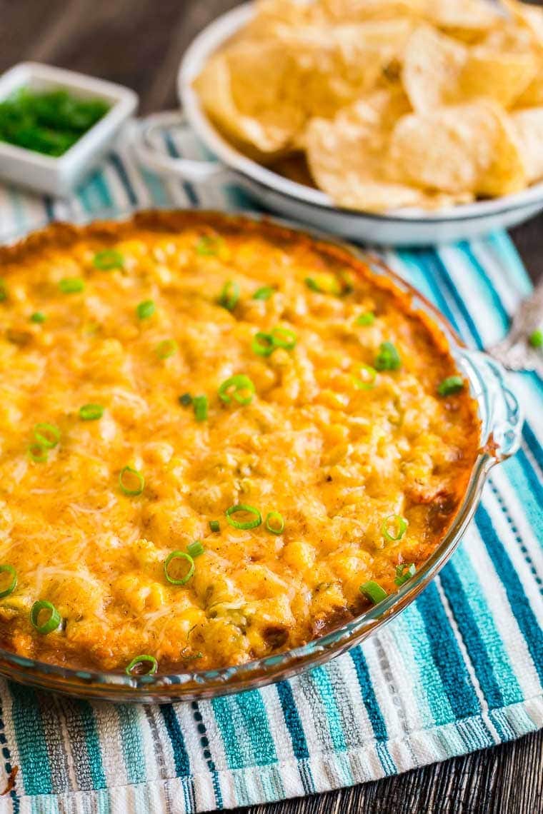 Cheesy Hot 7 Layer Dip - The ultimate appetizer for game day tailgating and parties! 