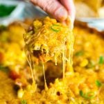 This Hot 7 Layer Dip is the ultimate game day or party recipe! It's super quick and easy to make and that melty cheese will keep everyone coming back for more!