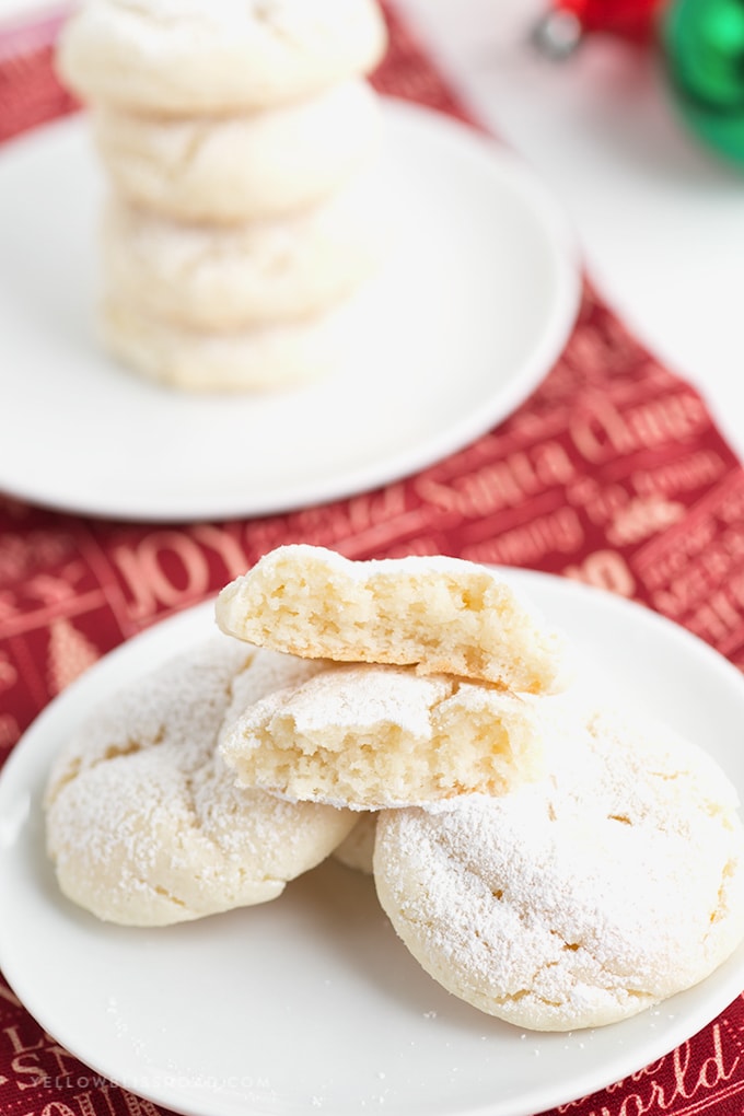 Snowball cookies made from cake mix - nut free - broken in half on a plate.