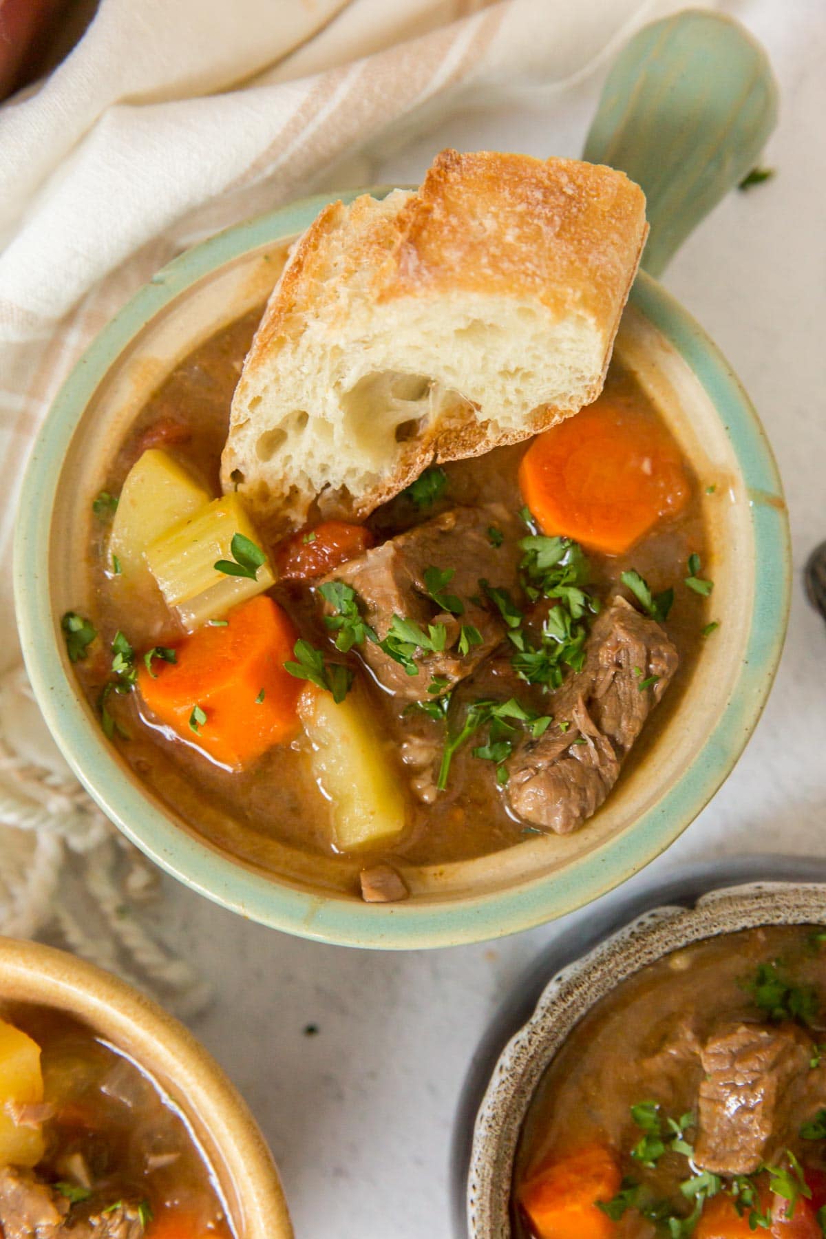 bowls of beef stew, bread