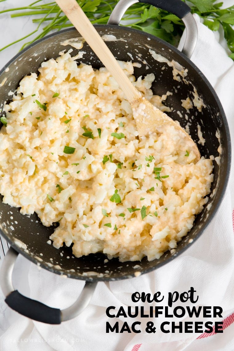 a skillet with cauliflower and cheese sauce with a wooden spoon and title text