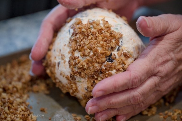 Olive cheese ball rolled in toasted parmesan walnuts