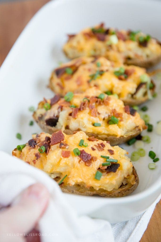 These Twice Baked Potatoes are stuffed to the brim with tender potato, cheddar and Parmesan cheeses and loads of bacon. A great side dish for any holiday!