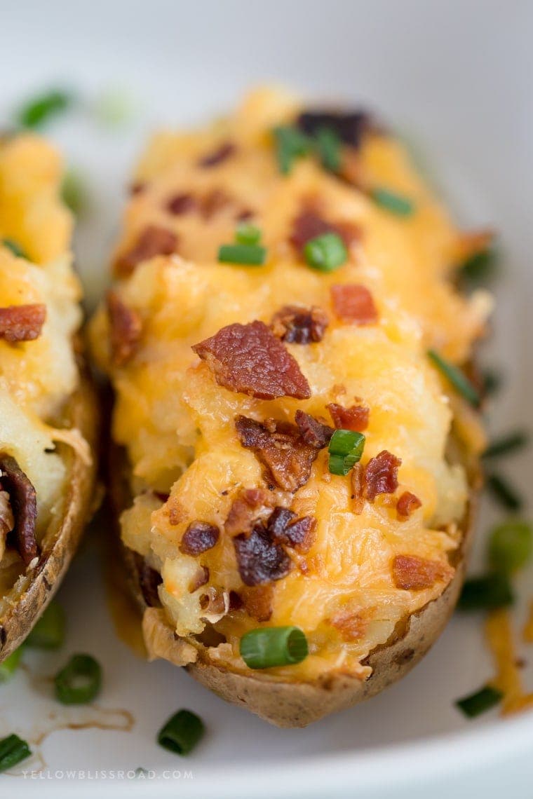 These Twice Baked Potatoes are stuffed to the brim with tender potato, cheddar and Parmesan cheeses and loads of bacon. A great side dish for any holiday!