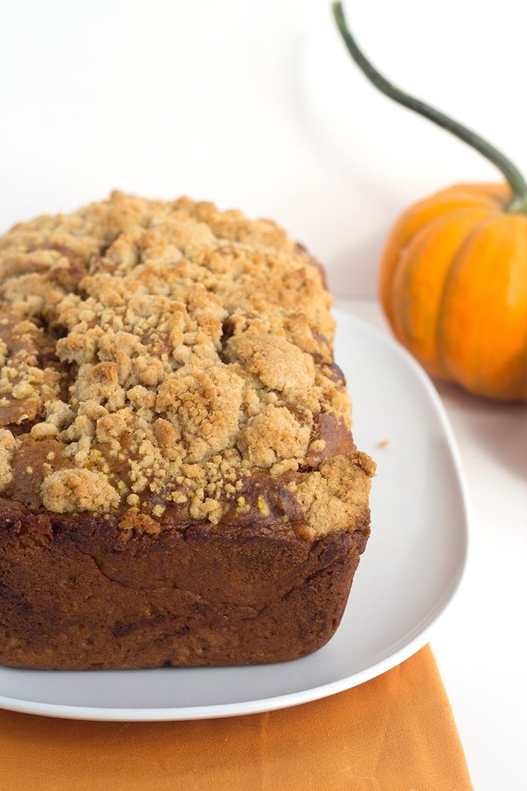 Pumpkin Bread with a Streusel topping - This dense, moist pumpkin bread full of spices and stopped with a streusel makes the perfect Fall quick bread! It's packed full of great flavor!