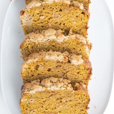 Pumpkin Bread with a Streusel topping - This dense, moist pumpkin bread full of spices and stopped with a streusel makes the perfect Fall quick bread! It's packed full of great flavor!