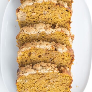 Pumpkin Bread with a Streusel topping - This dense, moist pumpkin bread full of spices and stopped with a streusel makes the perfect Fall quick bread! It's packed full of great flavor!