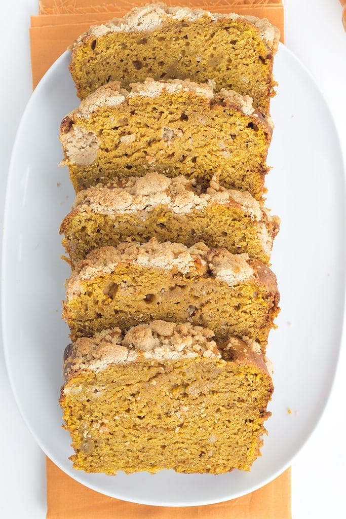 Pumpkin Bread with a Streusel topping - This dense, moist pumpkin bread full of spices and stopped with a streusel makes the perfect Fall quick bread! It's packed full of great flavor!