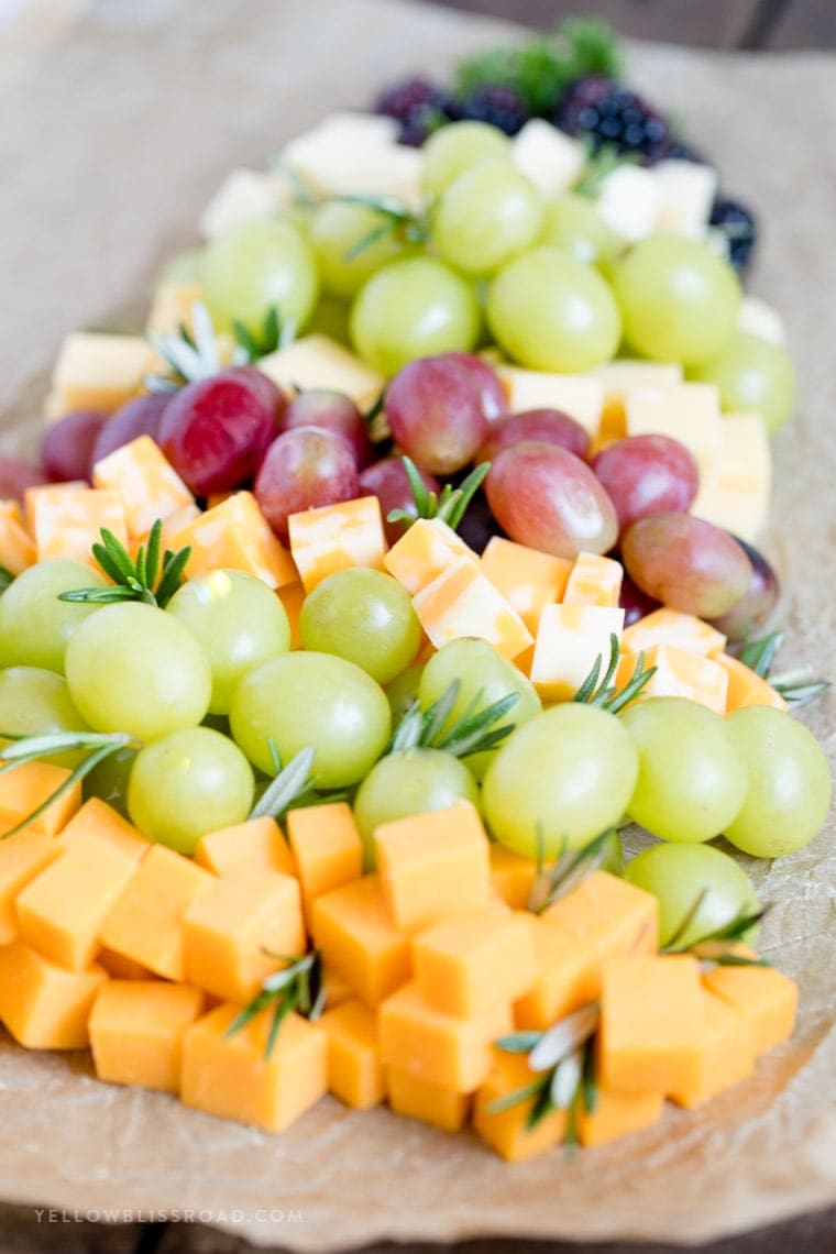 A side angle view of a fruit and cheese platter for christmas