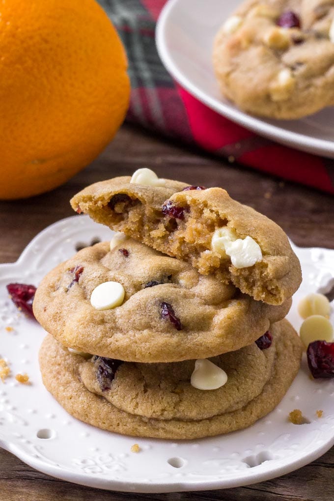 An Orange Cranberry White Chocolate Cookie broken in half to reveal the dense, chewy insides.