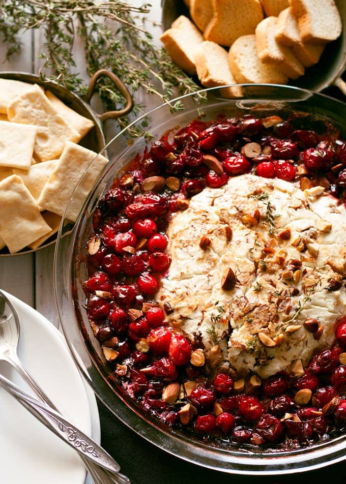A bowl of baked goat cheese with cranberries