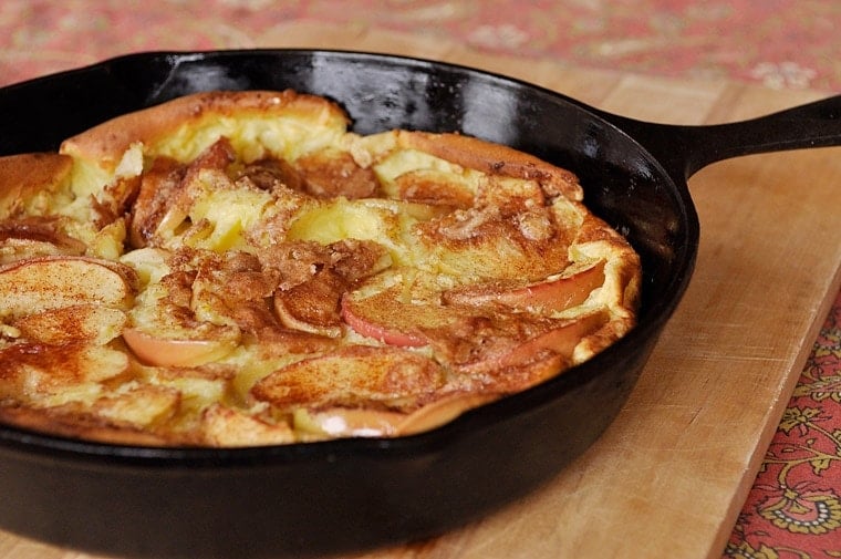 A cast iron pan with Dutch Baby Apple Pancake