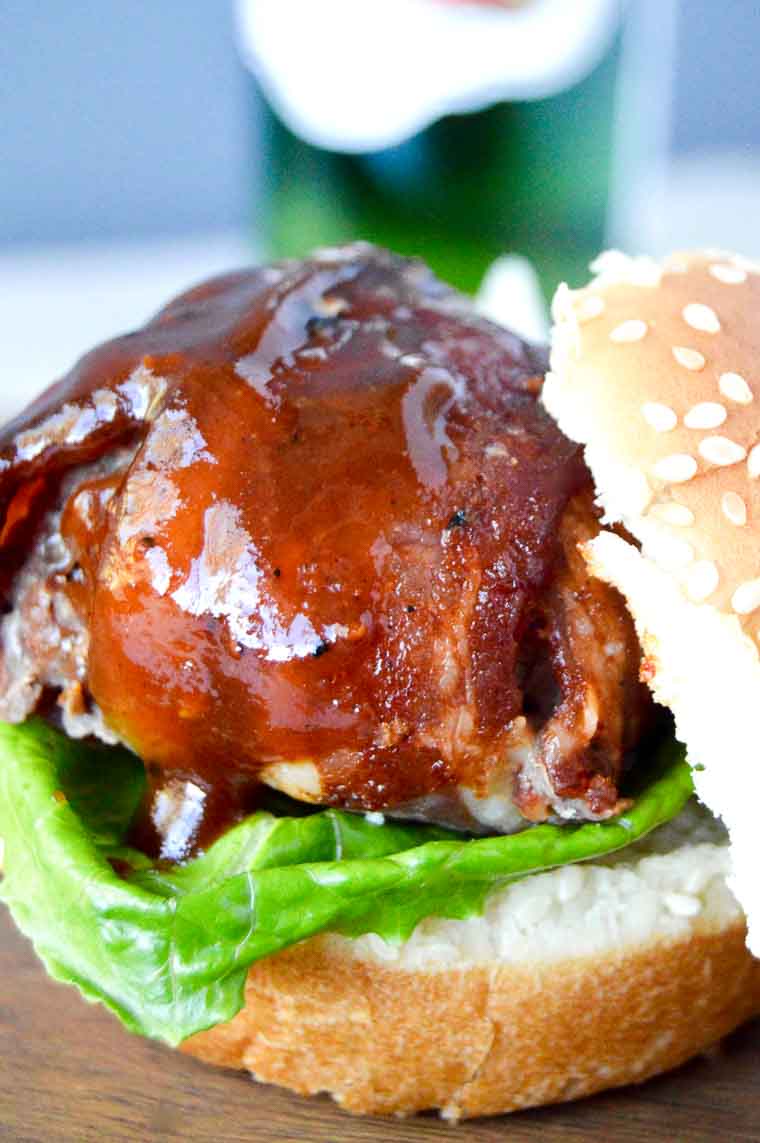 BBQ Bacon Meatball Slider slathered in BBQ sauce on a slider bun