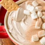 Cup filled with Hot Chocolate Dip with marshmallows and a graham cracker