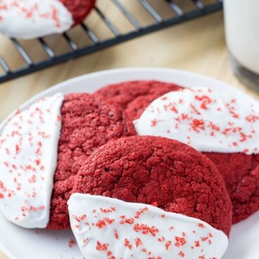 These red velvet cookies are soft, chewy & dipped in white chocolate. Perfect with a glass of milk.