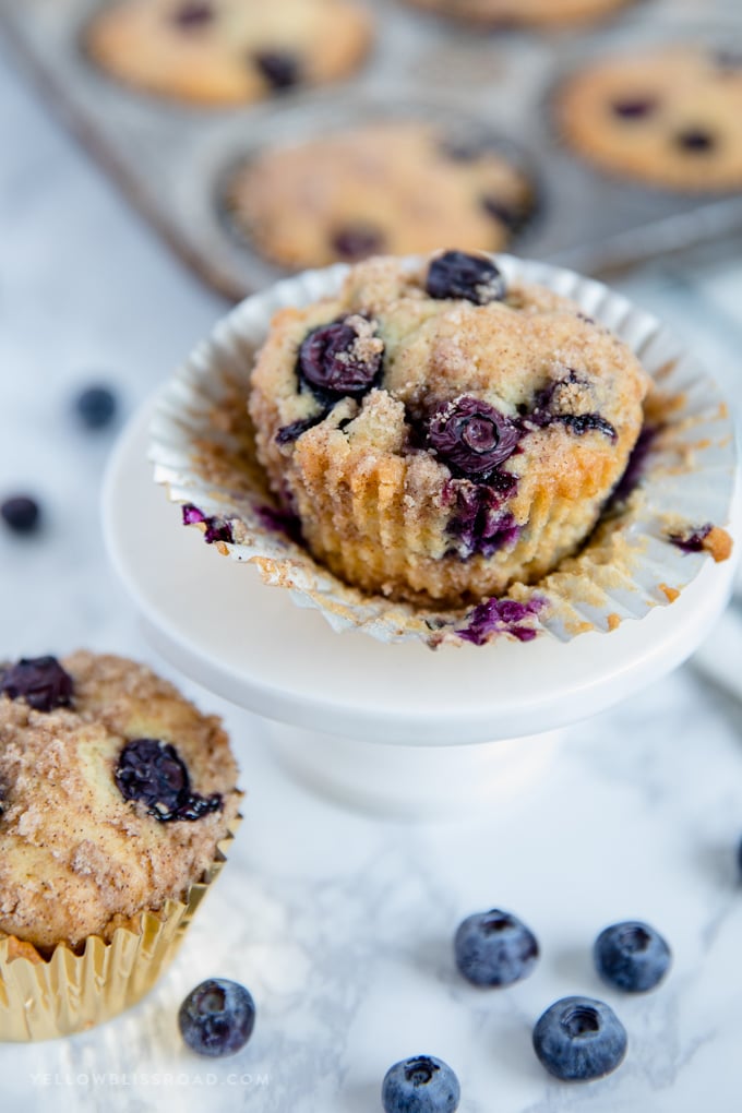 Blueberry Sour Cream Coffee Cake Muffins with the muffin paper spread open