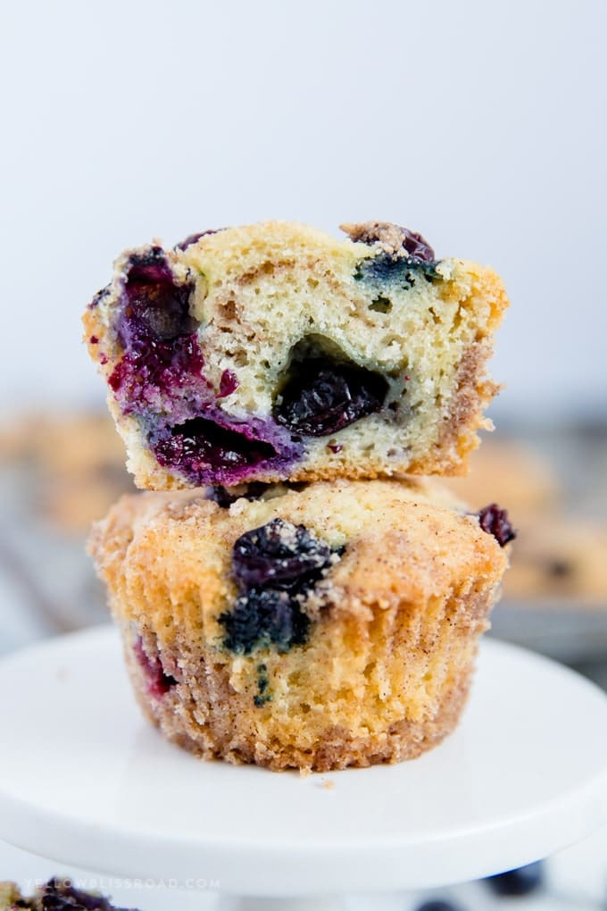 Blueberry Sour Cream Coffee Cake Muffins stacked with one sliced in half