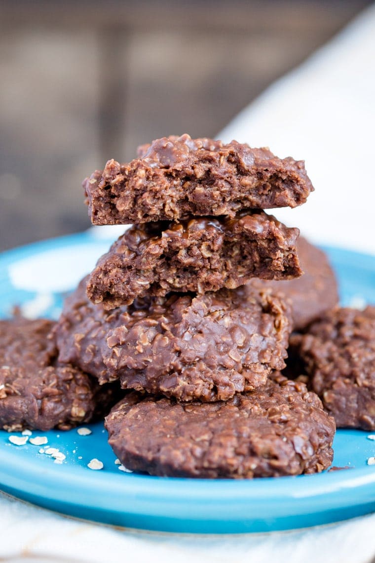 Chocolate No Bake Cookies stacked on a plate with one cookie split in half