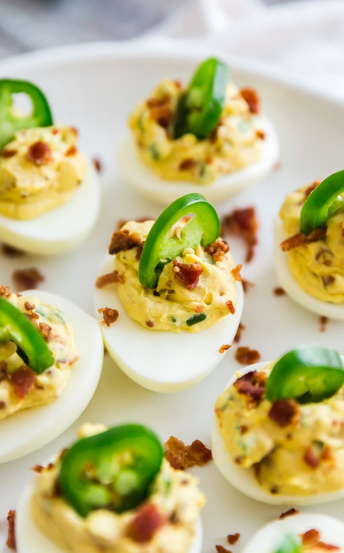Jalapeno Popper Deviled Eggs on a plate with the focus on the one in the middle.