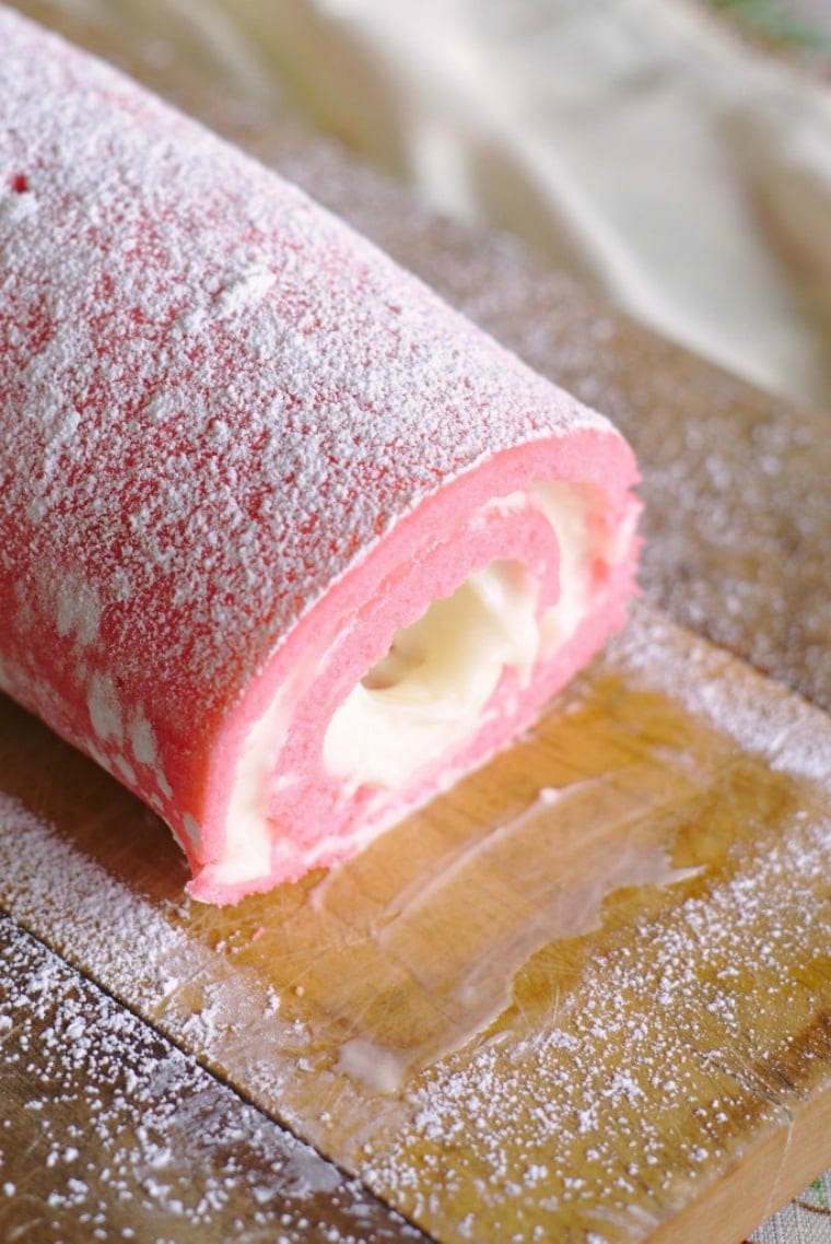 pink velvet cake roll ready to be sliced