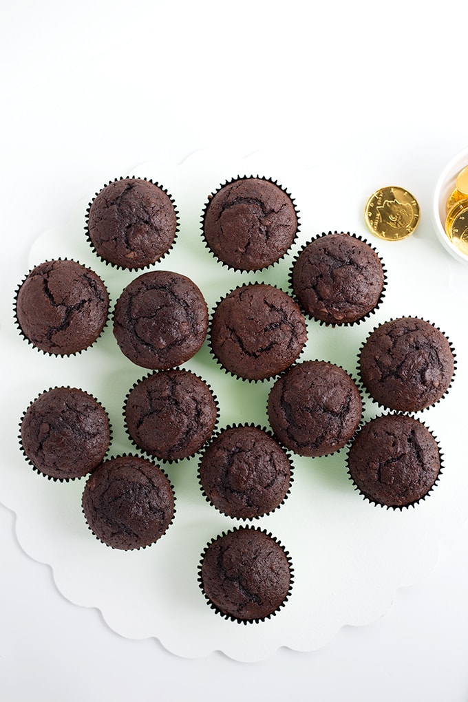 Chocolate cupcakes laid out to form a shamrock shape.