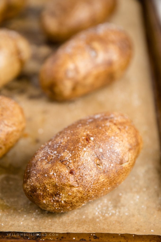 baked potatoes on a baking sheet lined with parchment paper