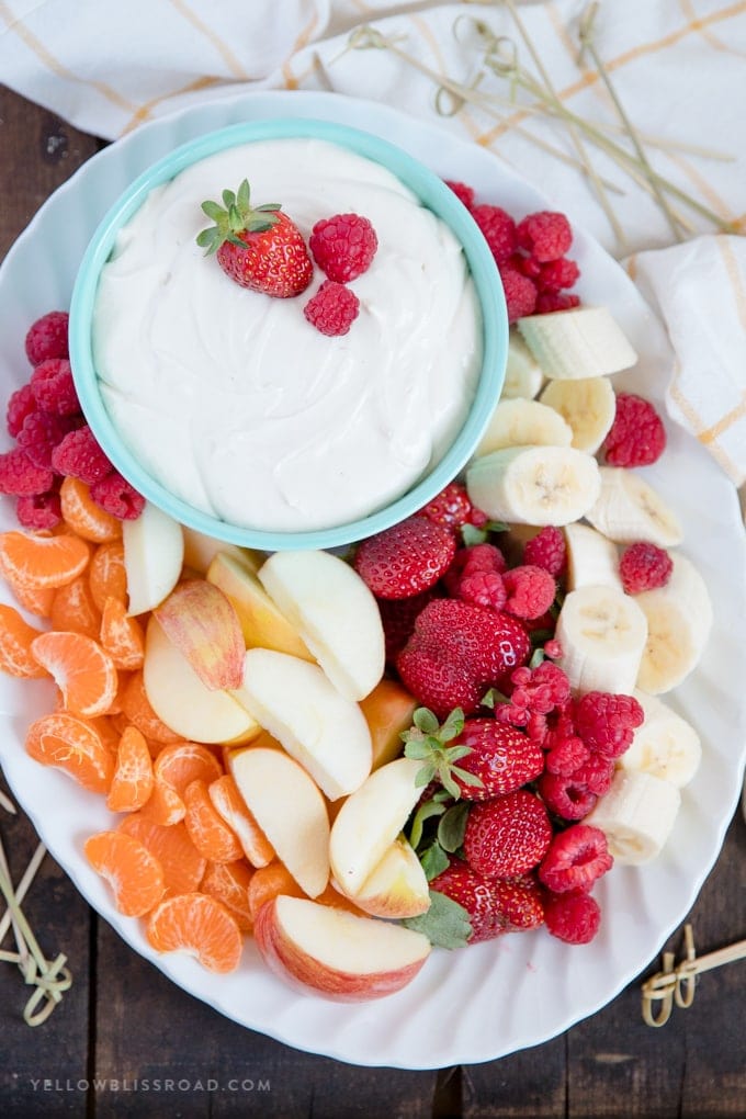 Platter of fresh fruit with a bowl of easy, 3 Ingredient Cream Cheese Fruit Dip 