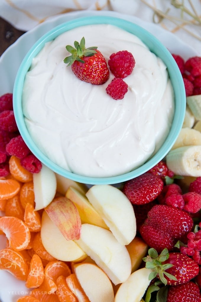 Bowl of easy, 3 Ingredient Cream Cheese Fruit Dip with strawberries, orange, bananas, raspberries and apples