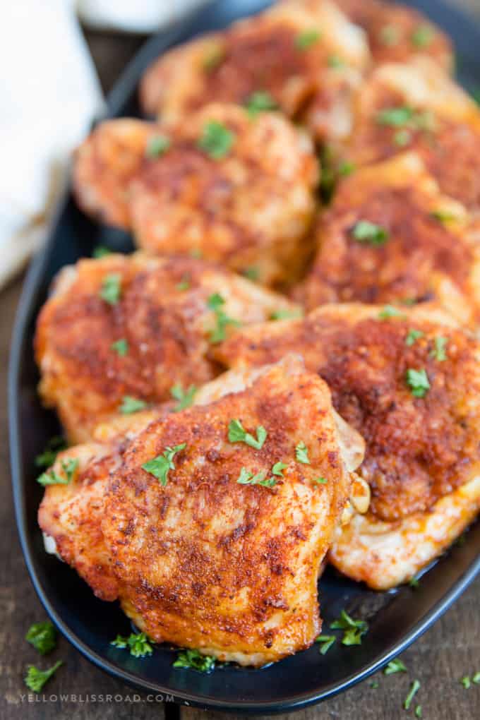 Crispy Baked Chicken Thighs on a black platter