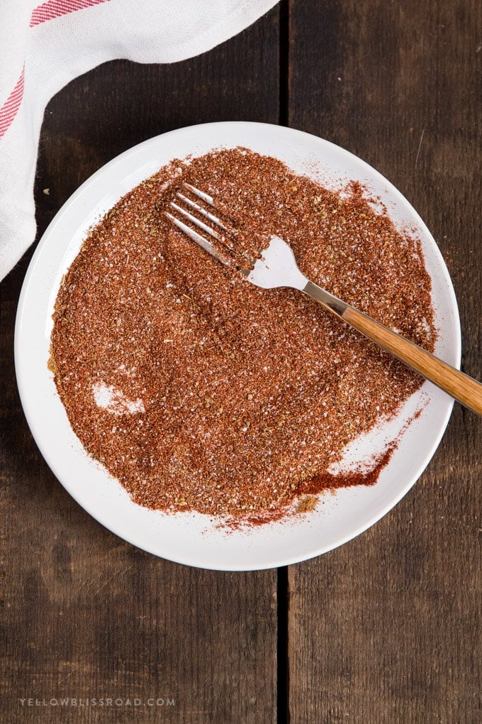 Homemade taco seasoning mixed together on a plate with a fork