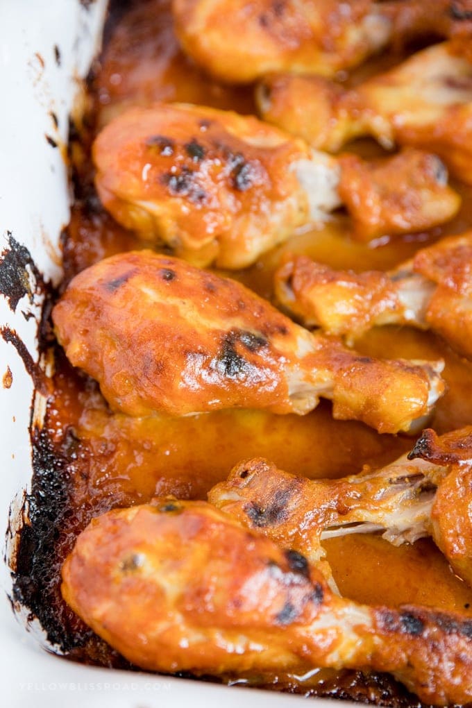Baked Honey Mustard Chicken Drumsticks close up image in a baking dish