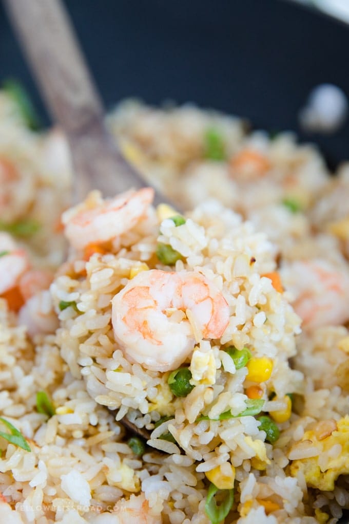 Close up of shrimp fried rice on a wooden spoon