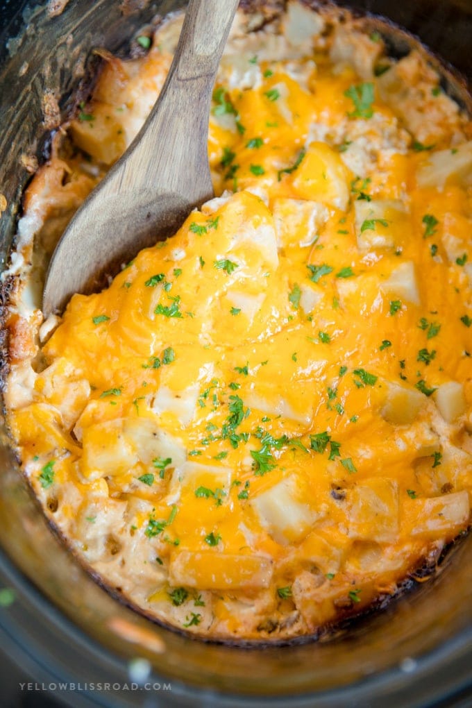 Crockpot Cheesy Potatoes - a delicious side dish with soft and tender chunks of fresh potatoes in a creamy, cheesy sauce all made easily in the slow cooker.