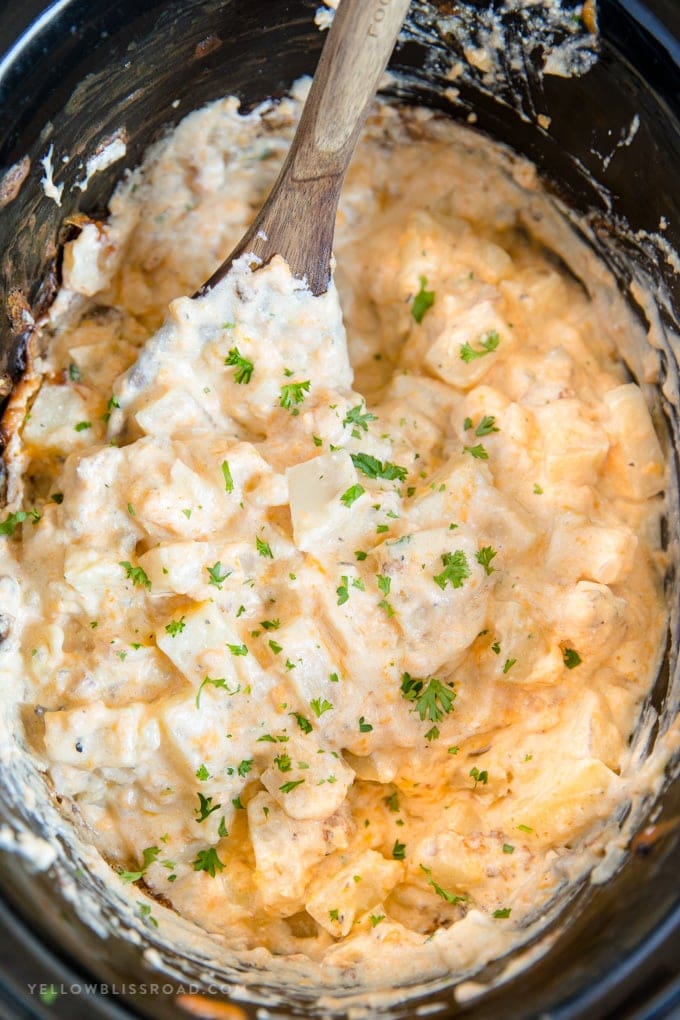 Crockpot Cheesy Potatoes - a delicious side dish with soft and tender chunks of fresh potatoes in a creamy, cheesy sauce all made easily in the slow cooker.