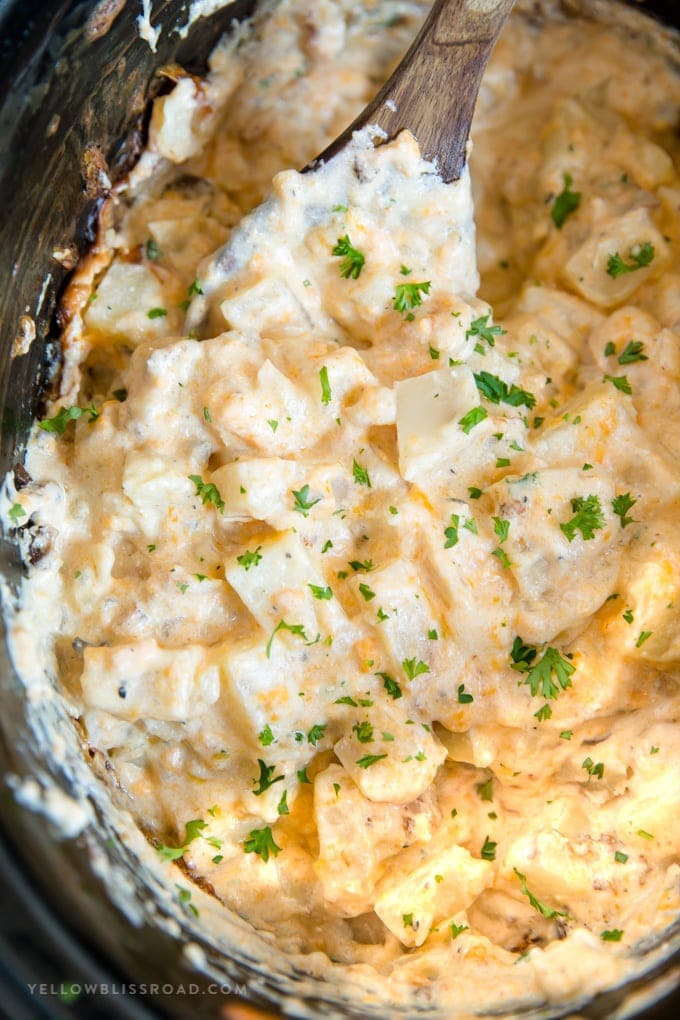 Crockpot Cheesy Potatoes - a delicious side dish with soft and tender chunks of fresh potatoes in a creamy, cheesy sauce all made easily in the slow cooker.