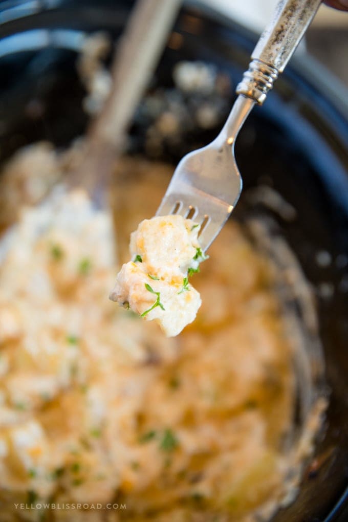 Crockpot Cheesy Potatoes - a delicious side dish with soft and tender chunks of fresh potatoes in a creamy, cheesy sauce all made easily in the slow cooker.