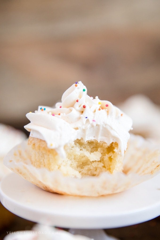 cupcakes with white frosting and sprinkles