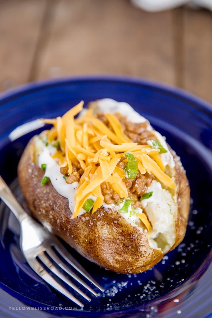 taco stuffed baked potato in a blue bowl