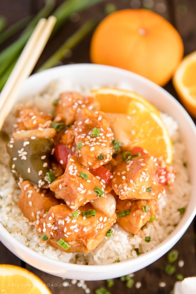 a bowl of crockpot orange chicken on a bed of rice