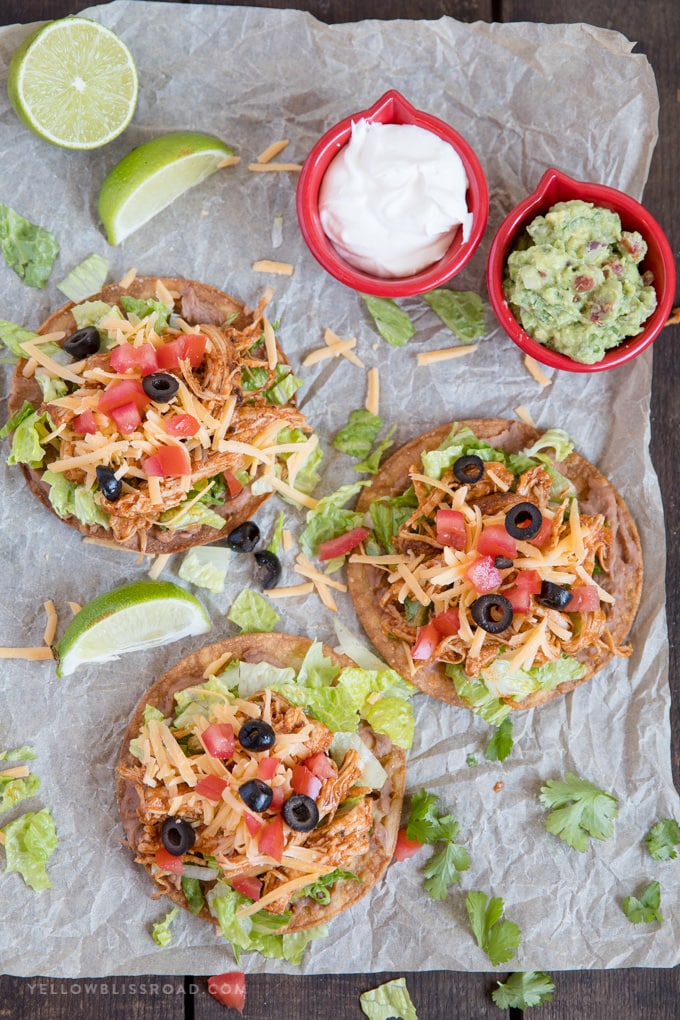 Overhead photo of 3 chicken tostadas with toppings.