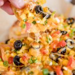 A close up of loaded chicken nachos