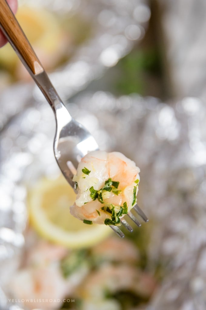 a foil packet shrimp on a fork