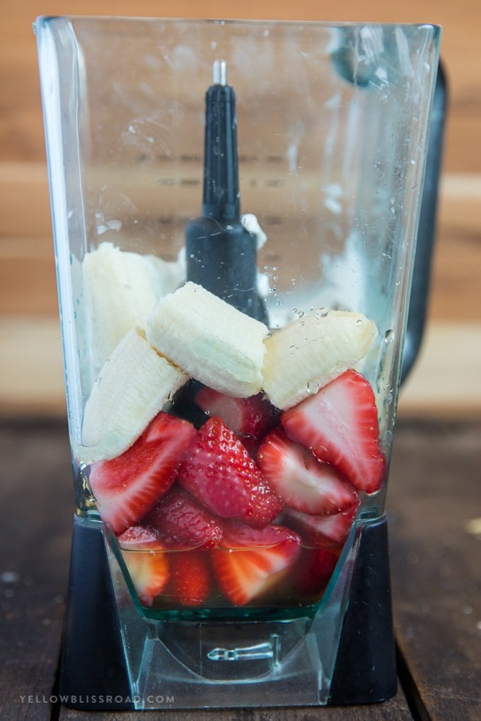 Strawberries, bananas, yogurt and honey in a blender 