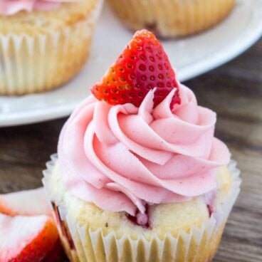 Strawberry cupcakes - moist vanilla cupcakes filled with strawberries and topped with strawberry frosting.