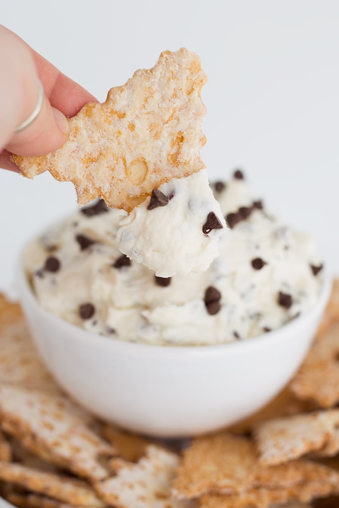 cannoli chips being dipped into cannoli dip